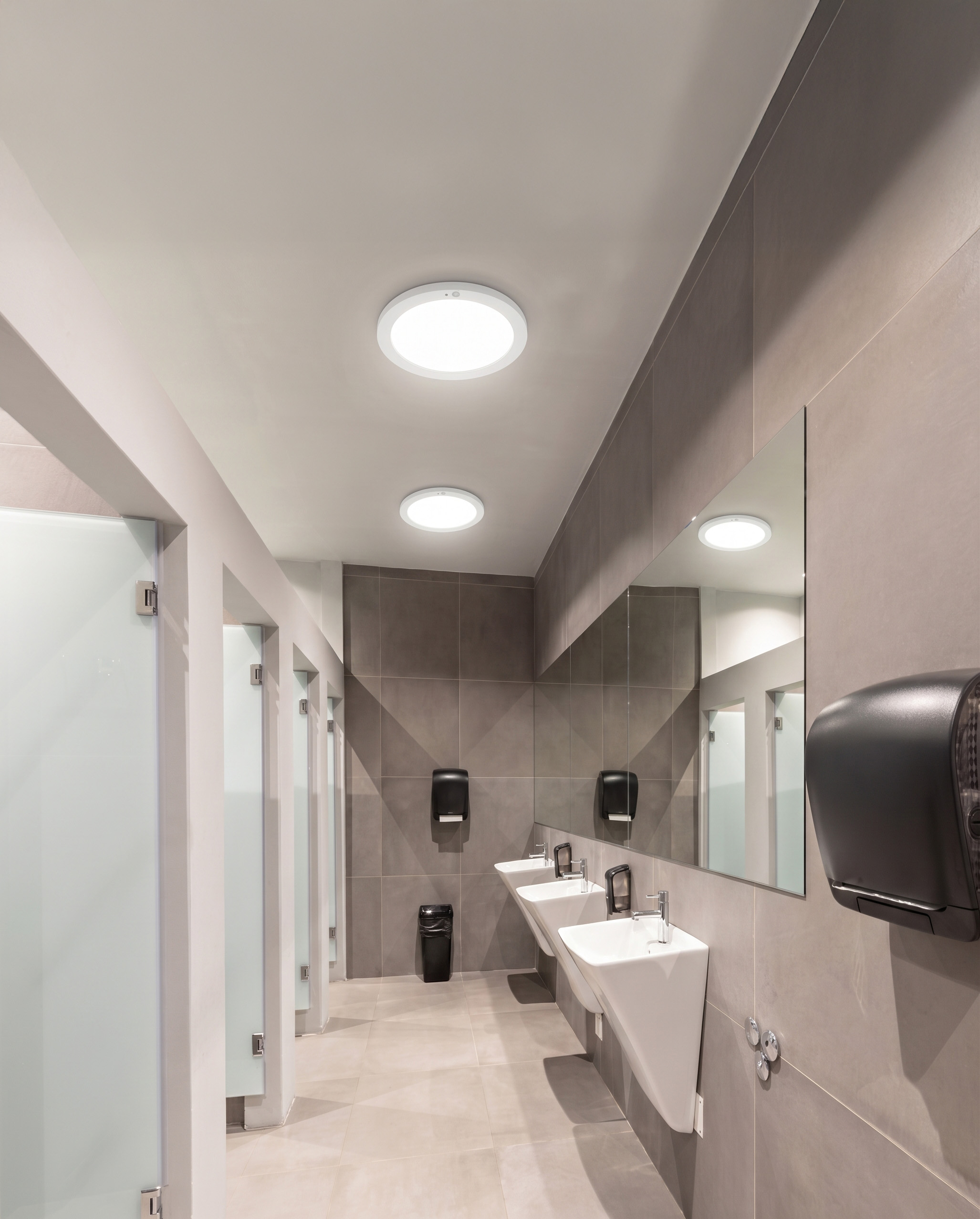 Washroom with basins, mirrors and round ceiling lights